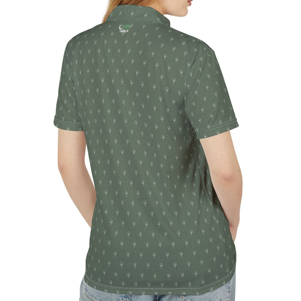 A woman with red hair is shown from the back wearing a short-sleeve polo shirt with a repeating white anchor pattern on a dark green base, paired with blue jeans against a plain white background.
