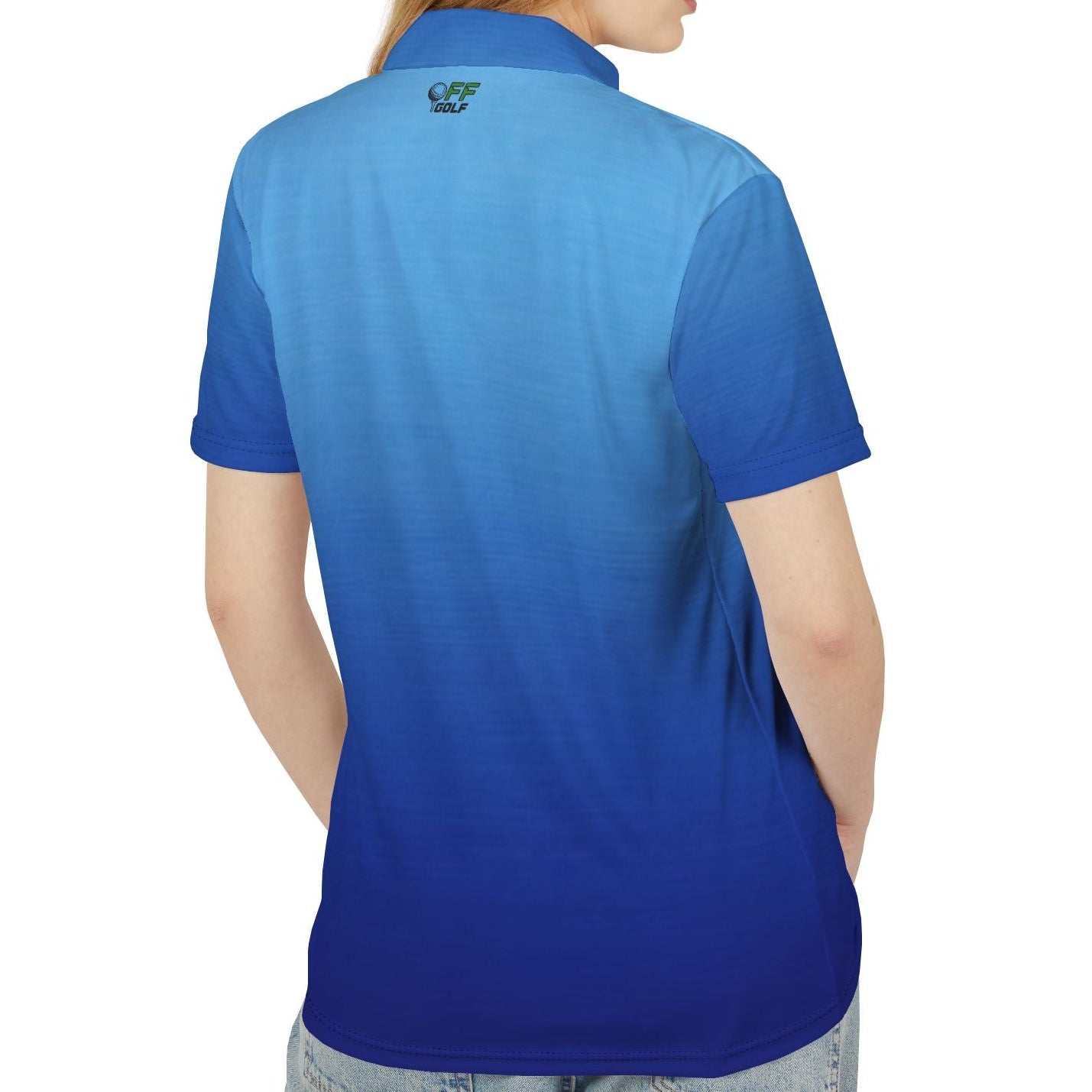 A woman shown from the back wearing a short-sleeve polo shirt with a blue gradient design, transitioning from a light sky blue at the shoulders to a deep royal blue at the waist. The polo features a small embroidered logo on the upper back.