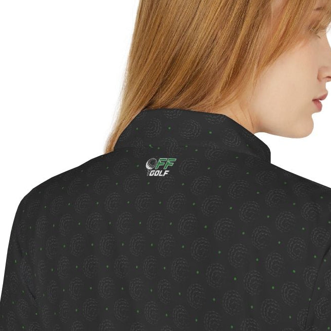 Person wearing a black polo shirt with purple patterns on a white background