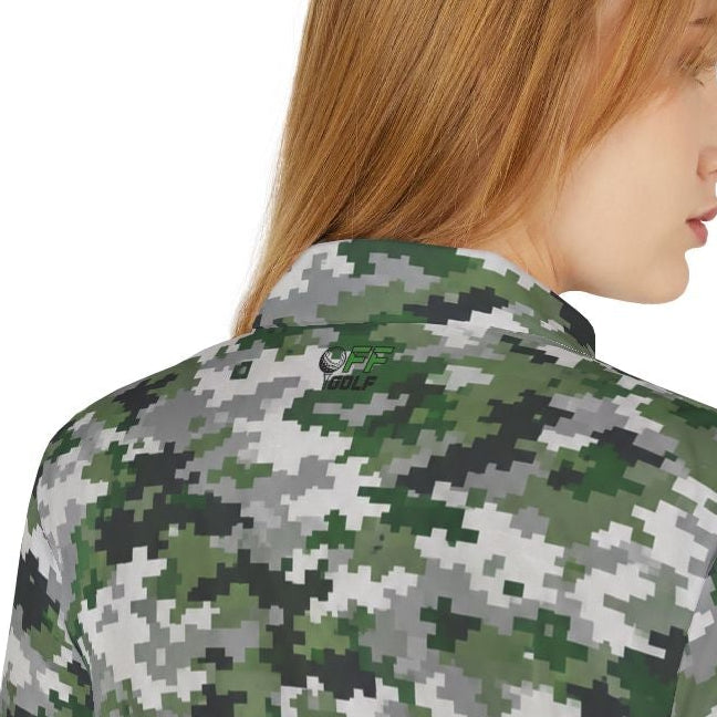 A woman with red hair is shown from the back wearing a short-sleeve collared polo shirt with a green, gray, and black digital camouflage pattern, paired with light blue jeans, against a plain white background.
