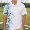 A man wearing a white short-sleeve polo shirt with a blue digital pixel pattern on the left side, standing on a golf driving range with golf balls and green grass in the background.