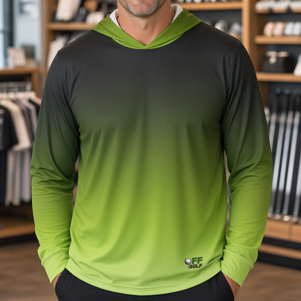 A man wearing a long-sleeve gradient hooded shirt with a black-to-green color transition, standing inside a retail store.