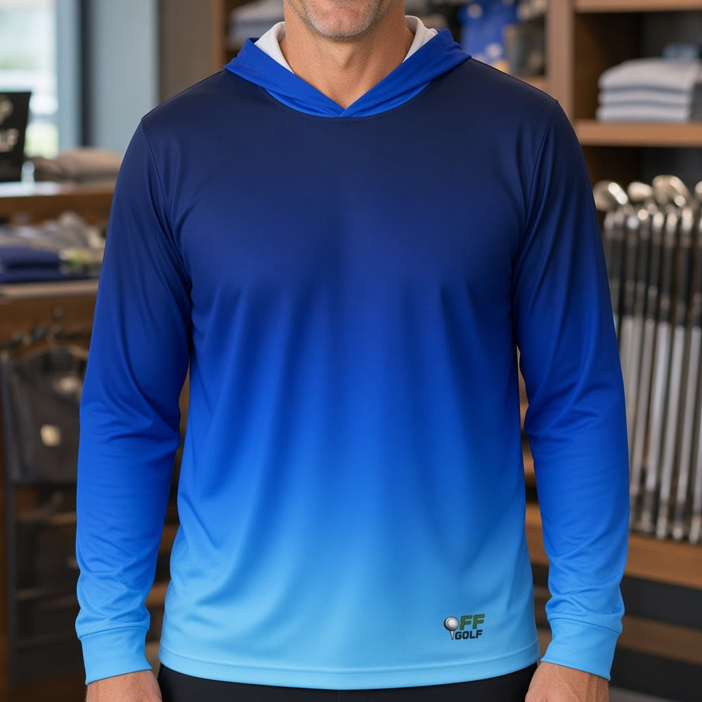 A man wearing a blue gradient hooded long-sleeve performance shirt stands in a retail store. The shirt features a dark navy hood and upper chest fading to a light blue at the hem, with a small 'FF GOLF' logo near the bottom right.