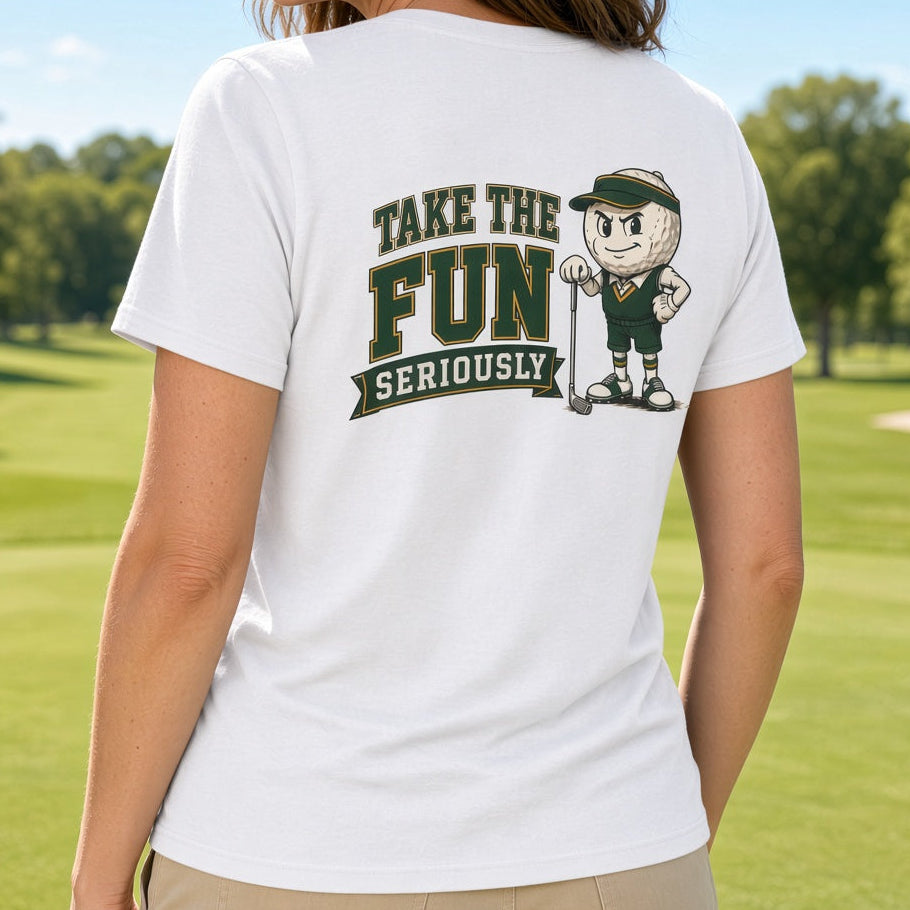 A woman standing on a golf course wearing a white t-shirt with a dark green and black graphic that reads 'TAKE THE FUN SERIOUSLY' next to a cartoon character.