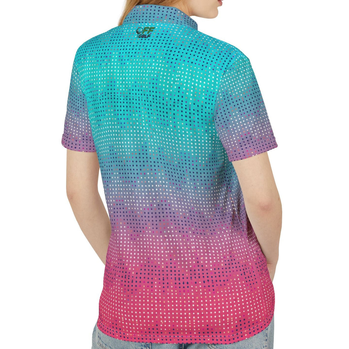 A woman shown from the back wearing a short-sleeve collared shirt with a gradient pattern transitioning from turquoise blue to purple and pink, paired with light blue jeans against a plain white background.