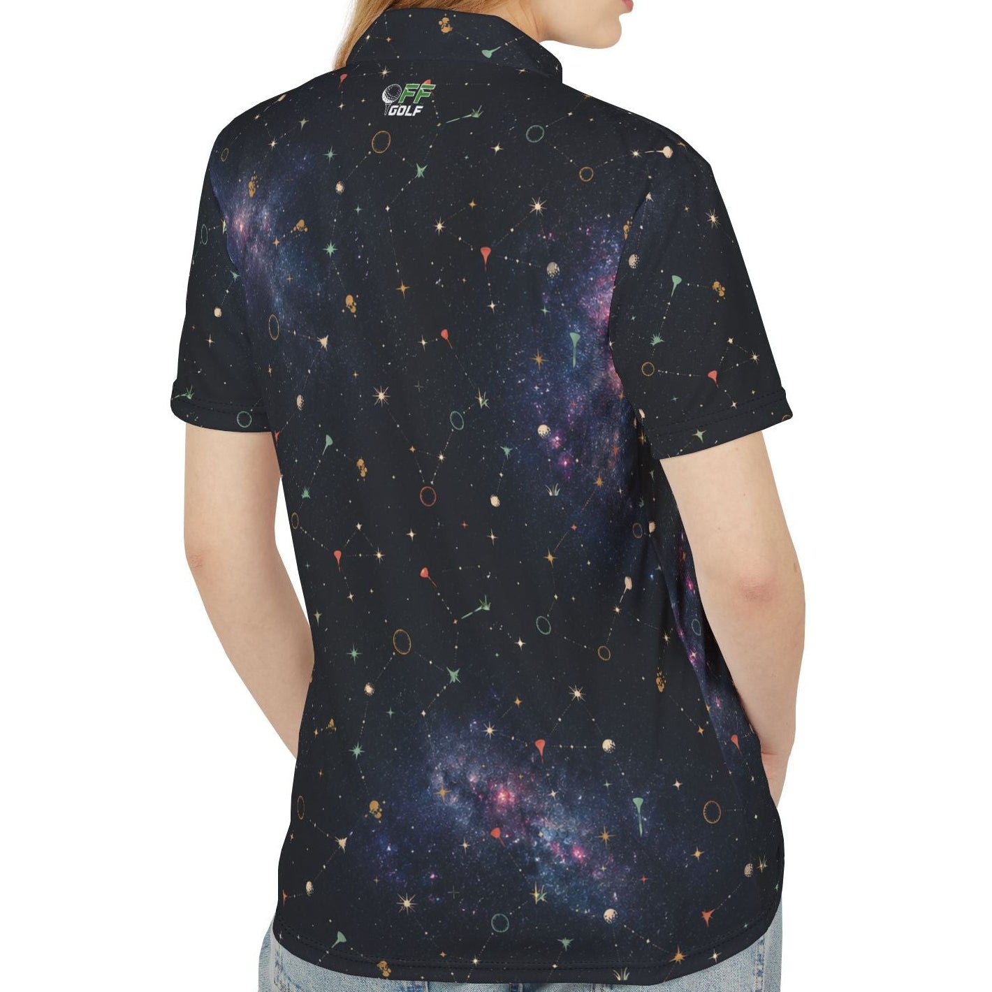 A woman shown from the back wearing a short-sleeve polo shirt with a dark galaxy print, paired with light blue jeans, against a plain white background.