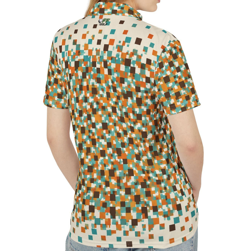 A woman shown from the back wearing a short-sleeve collared button-up shirt with a multicolor pixelated geometric pattern in orange, teal, brown, and cream, paired with light blue jeans against a plain white background.