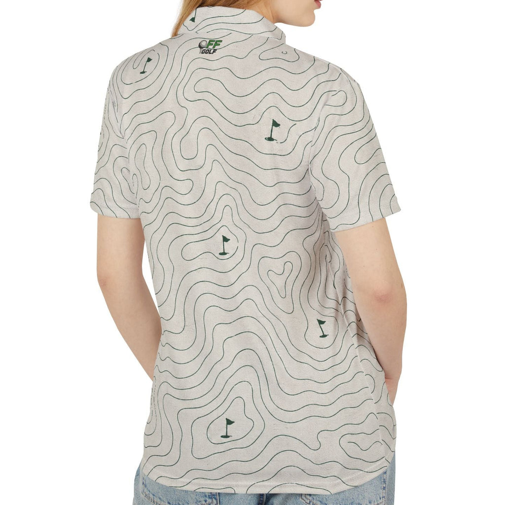 A woman shown from the back wearing a short-sleeve polo shirt with a light beige background and a dark gray topographic contour line pattern, paired with light blue jeans, against a plain white background.