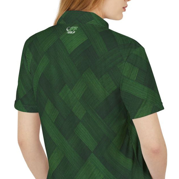 A woman with long red hair is shown from the back wearing a dark green short-sleeve polo shirt and light blue jeans against a plain white background.